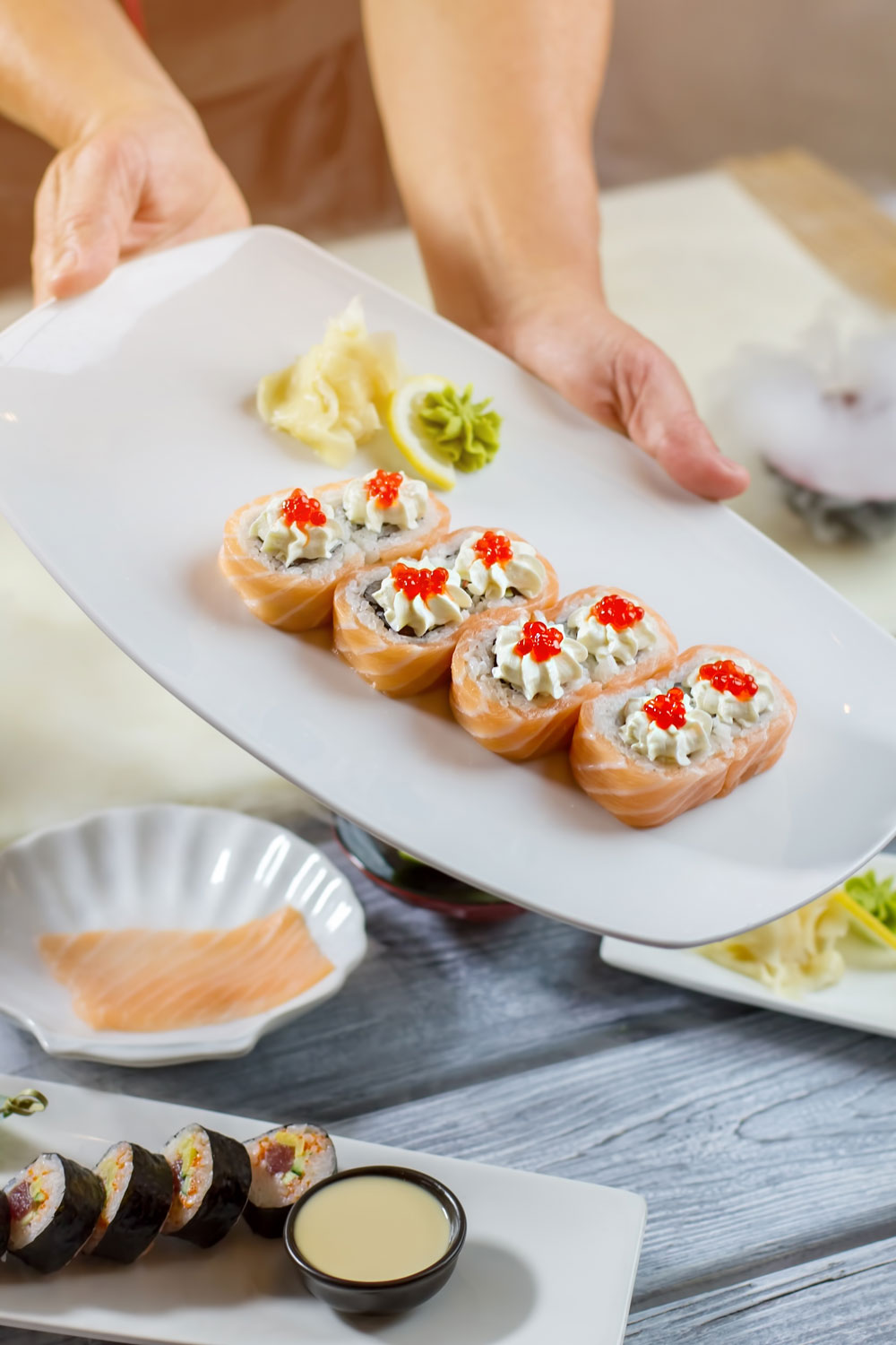 man-s-hands-hold-sushi-plate-bluefin-sushi-restaurant-in-Denver
